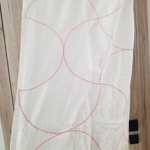 The Land of Nod Cream Curtain Panel with Pink Stitching